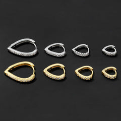 Set of simple temperament summer cool love heart-shaped gold and silver ear clips with rhinestone accents on black background