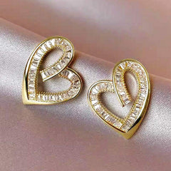 Yellow gold hollowed heart shape ear studs with inlaid zircon decoration