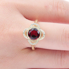 Copper inlaid zircon ring with red center stone and electroplated copper band on finger