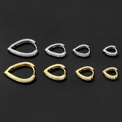 Set of simple temperament summer cool love heart-shaped gold and silver ear clips with rhinestone accents on black background