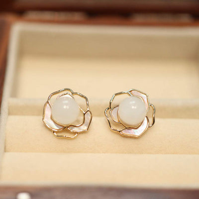Natural Hetian white jade earrings with gold floral design in jewelry box