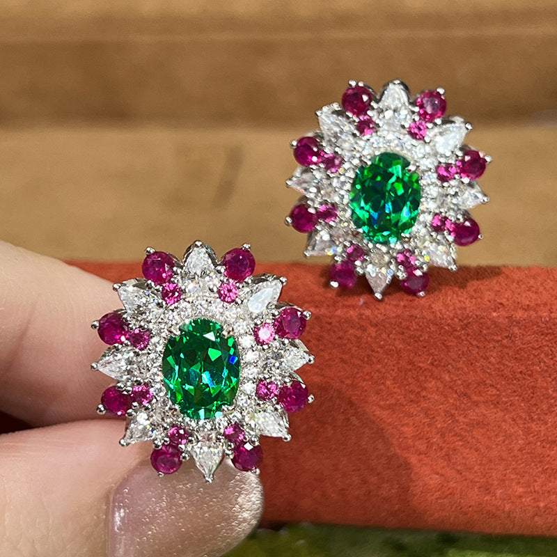 Colorful stud earrings with oval green zircon center, surrounded by white and pink geometric stones in white gold setting for women