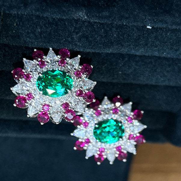 Colorful stud earrings with oval green zircon center and white gold geometric flower design