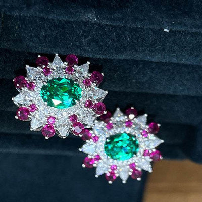 Colorful stud earrings with oval green zircon center and white gold geometric flower design