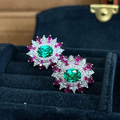 Colorful stud earrings with green oval zircon center and pink and white geometric flower design in white gold setting