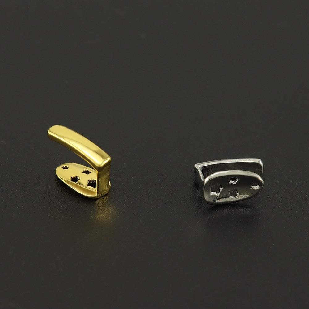 gold and silver electroplated metal Teeth Joint pieces on black background