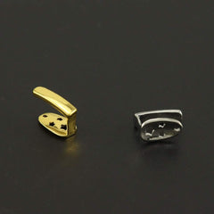 gold and silver electroplated metal Teeth Joint pieces on black background
