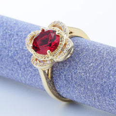Copper inlaid zircon ring with red center stone and gold electroplated copper band